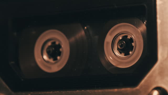 Audio Cassette Playback in Vintage Tape Recorder in Soft Flickering Light