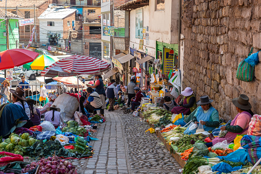 cusco, peru. 5th october, 2022: quechua woman are selling vegetables and food at street of cusco city, peru