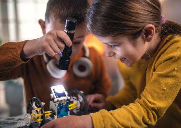 istock kids making diy robot by looking from digital tablet at home 1461388902