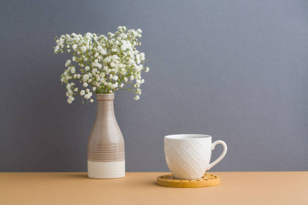 istock white flowers on a grey background. White flowers in a vase. coffe cup 1461389396