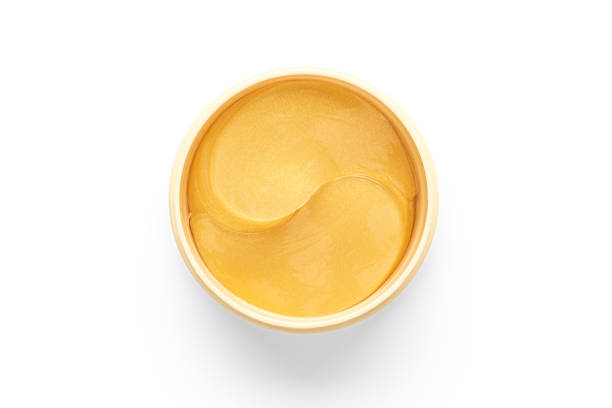 istock Cosmetic golden patches in jar on white background 1461391488