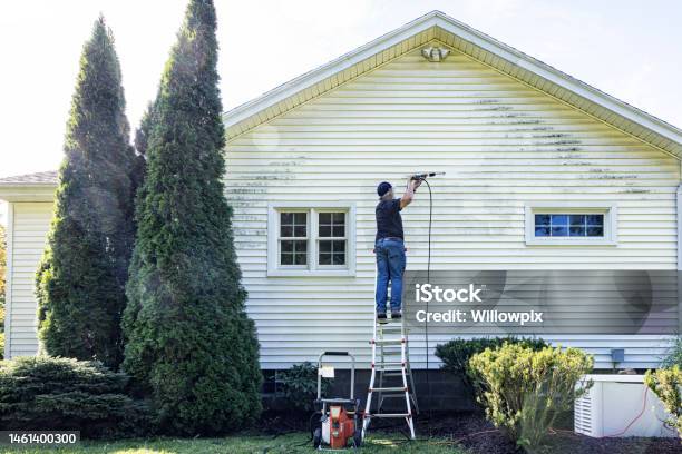Senior Man Up On Ladder Diy Power Washing House Siding Stock Photo - Download Image Now