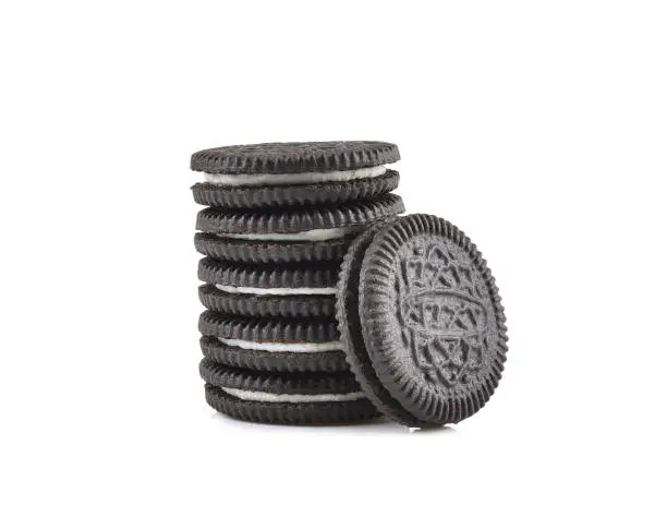 Stack of chocolate cookies and cream isolated on white background.