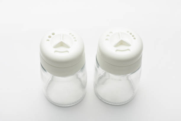 High angle view empty glass salt and pepper shakers on the white background