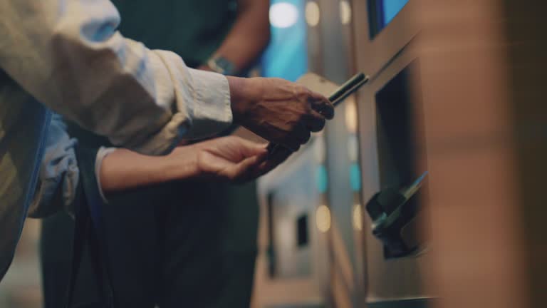 Close-up of Elderly man's hands are using his phone to pay for movie tickets.