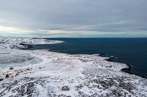 Winter landscape with snow-covered rocks. Arctic Ocean.