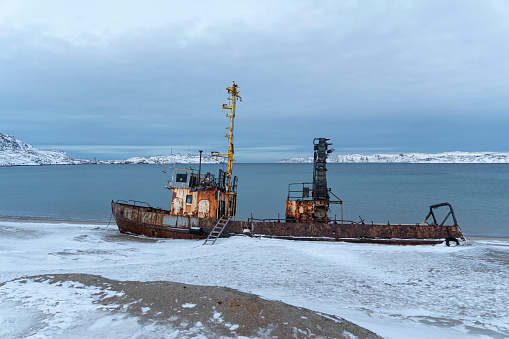 A wrecked fishing vessel washed ashore in the vicinity of Teriberka, Murmansk region, Barents Sea, Far North, Arctic