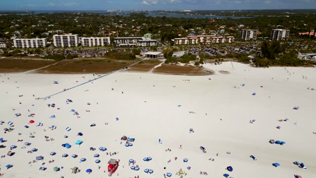 Aerial rise reveal tourists on Siesta Key Sarasota Beach Florida USA