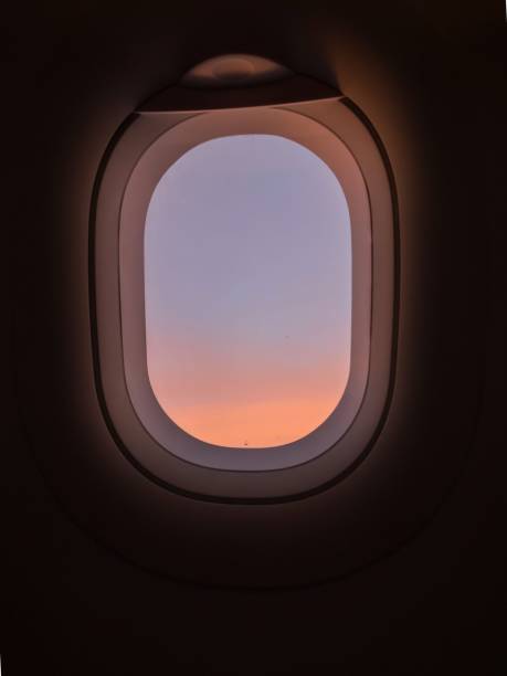 istock Typical airplane window view with pastel sky sunset and dark background wallpaper dreaming atmosphere concept 1461419326
