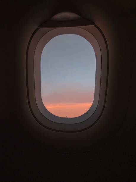 istock Typical airplane window view with pastel sky sunset and dark background wallpaper dreaming atmosphere concept 1461419334