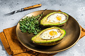 Brunch with Baked Avocado and Egg. Gray background. Top view