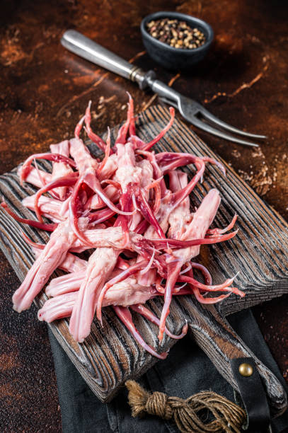 istock Fresh Raw Duck Tongue, poultry offal. Dark background. Top view 1461420486