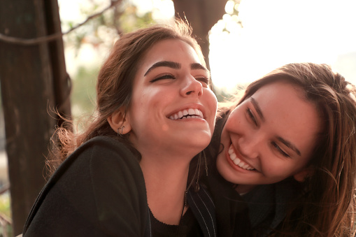 Close up portrait of two beautiful happy young women