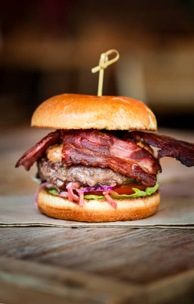 istock Freshly flame grilled bacon burger in gourmet restaurant 1461424566