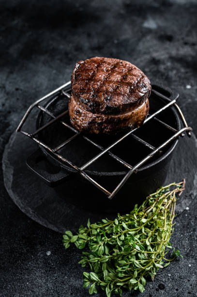 istock Fillet Mignon grilled beef Steak on a grill. Black background. Top view 1461424621
