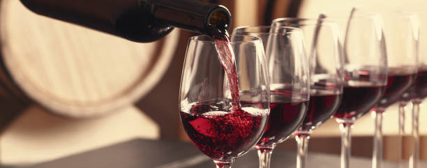 istock Pouring wine from bottle into glass. Banner design 1461426281