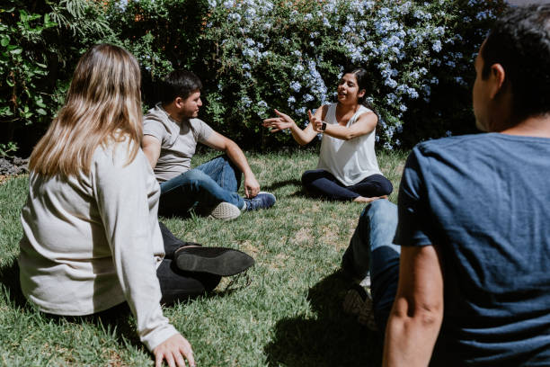 istock hispanic young people seated in circle on grass and participating at group therapy session in Mexico Latin America 1461426402
