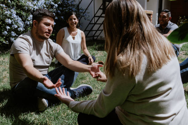istock hispanic young couple seated in circle on grass and participating in group therapy session in Mexico Latin America 1461426403