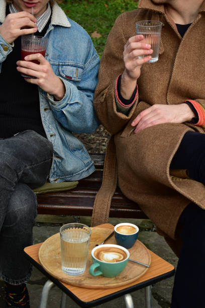 istock Two white males  drinking coffee in a public park 1461426642