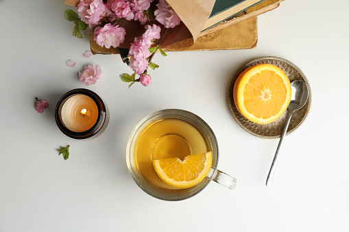 Flat lay composition with cup of freshly brewed tea on light table