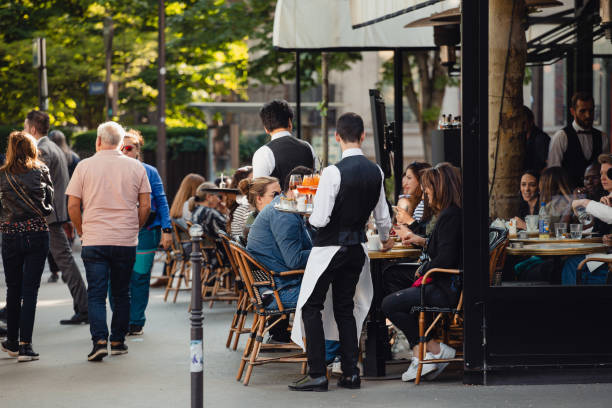 Paris, France - May 28, 2022: Cozy streets of Paris during the day - a lot of people in popular places