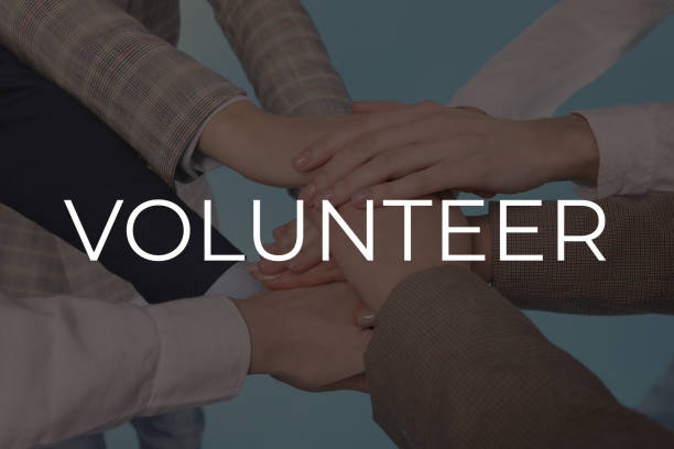 istock Group of volunteers putting hands together on light background, closeup 1461428242