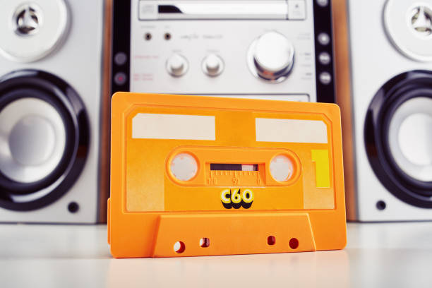 Audio cassette tape with hi-fi stereo player at the background