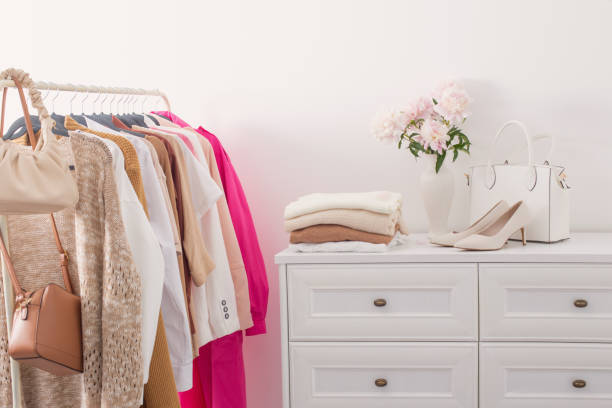 istock female clothes on hangers  in  white room 1461430746