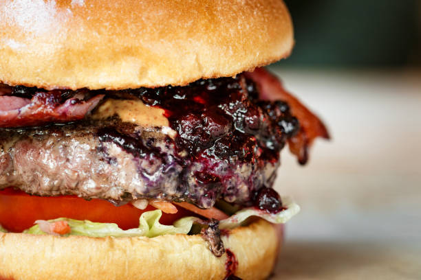 istock Freshly flame grilled bacon cheeseburger on wooden table 1461432429