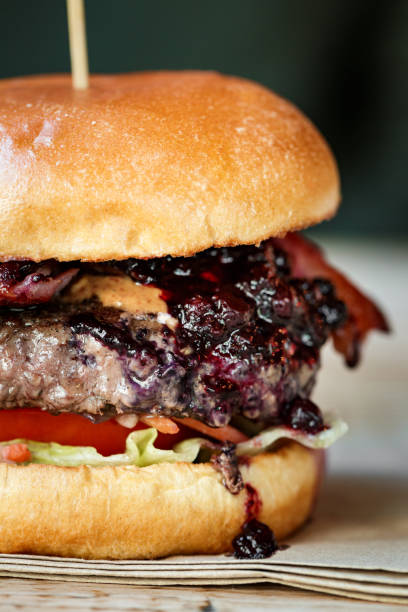 istock Freshly flame grilled bacon cheeseburger on wooden table 1461432440