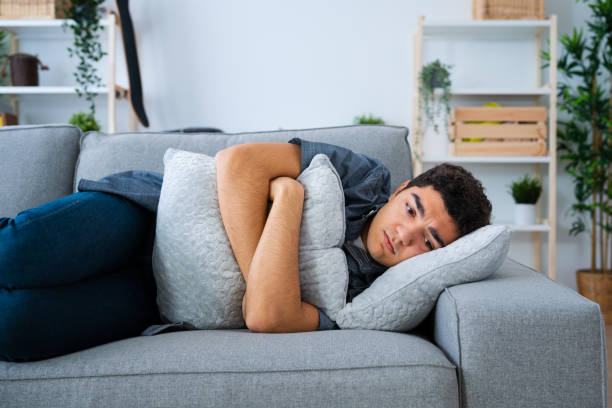 istock Depressed hispanic teenager boy lying on side 1461432893