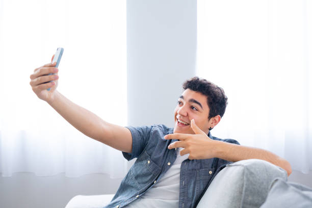istock Hispanic teenager boy live streaming 1461432899