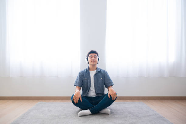istock Hispanic teenager boy relaxing sitting on floor 1461433090