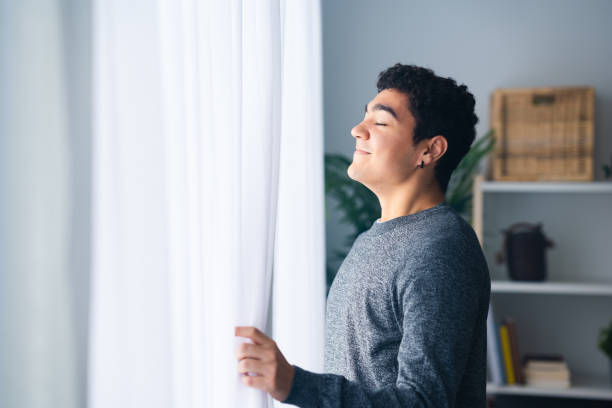 istock Hispanic teenager boy breathing deep indoors 1461433139