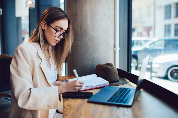 istock Beautiful lady with laptop working in cafe 1461433469