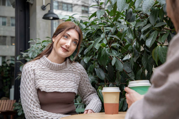 istock Young couple sitting in cafe with coffee and talking 1461436861