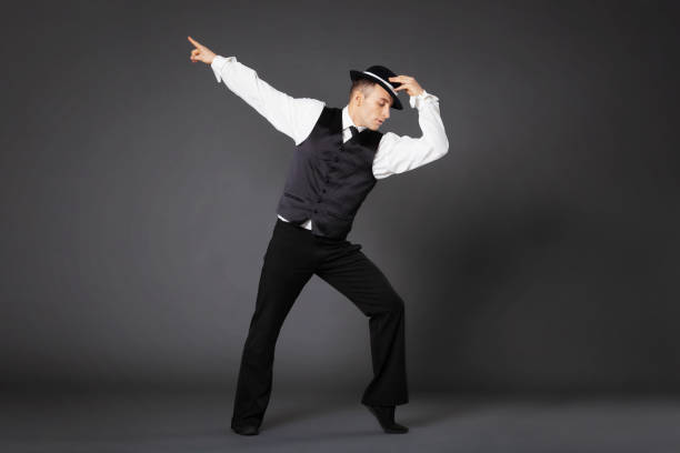 confident young man dancing in gangster style suite. - men 20s cut out 30s imagens e fotografias de stock