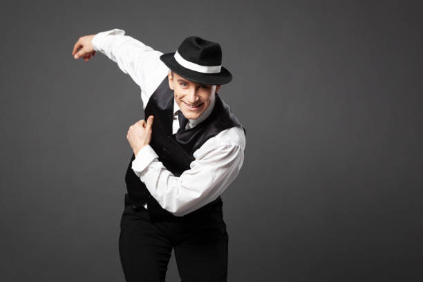 istock Confident young man dancing in gangster style suite. 1461437501