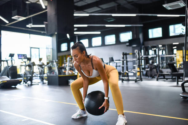 istock Athletic Female Increasing Core Strength With Medicine Ball 1461440741