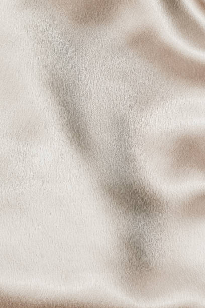 istock Beige silk fabric texture, Satin fashion Background for content. 1461441758