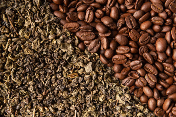 istock Background of green tea leaves and coffee beans copy space 1461449635