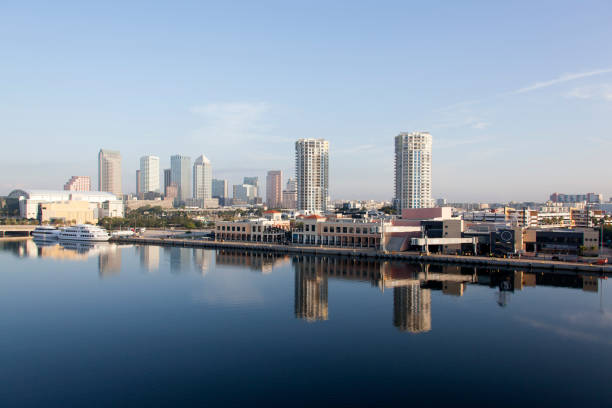 People walk on the St. Petersburg city coastal waterfront St. Pete Pier boardwalk path on Florida's Gulf Coast in the Tampa Bay area.  It's known for its pleasant weather and is nicknamed the “Sunshine City”
