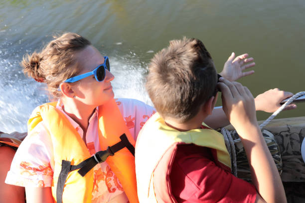 istock Mother with son in motor boat that goes through estuary 1461451920