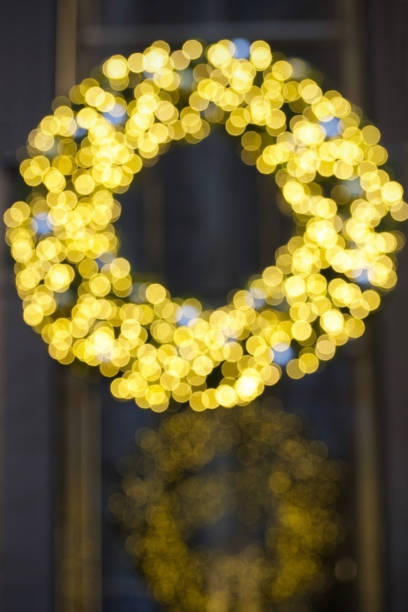 a ring of sparkling gold light on a dark background with repeating reflections of gold circles