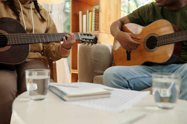 istock Teacher and Student Playing Guitar 1461454412