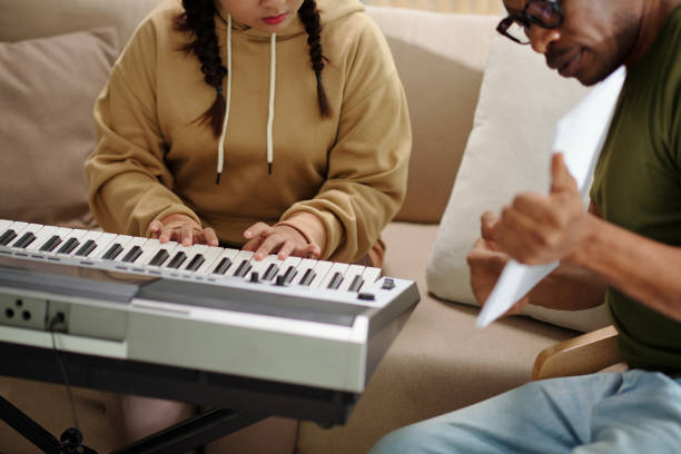istock Girl Leaning Playing Synthesizer at Home 1461454984