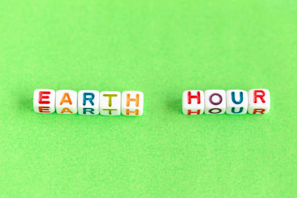 istock Phrase Earth Hour made out of beads on bright green background 1461459861