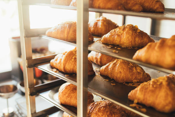 istock Freshly baked croissants on a rack at the kitchen. 1461460513