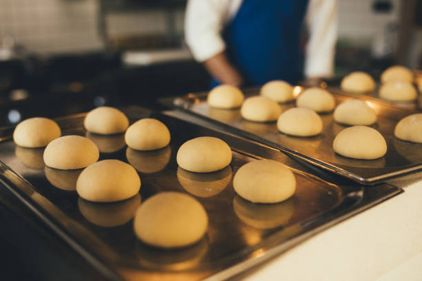 istock Raw dough buns on a tray at the kitchen. 1461460567