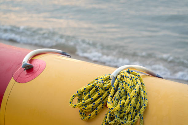 Yellow banana boat, close up. Sea waves at the background.